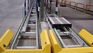 Two Chain conveyors with support tool by loading and unloading für specific pallets side by side; on picture chain conveyors with two chain belts.