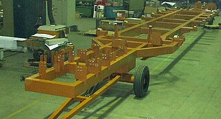 Installation and transport carriage for high-tension and control current channels of rail vehicles. Required assemblies and components can be positioned exactly on the carriage. The pre-assembly and transport carriage is then driven under the car body of the rail vehicle, where the parts can be finally assembled.