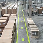 Lots of cardboard boxes lying around in an industrial hall