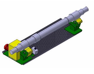 Illustration: Driven bench grinder with wheelset shafts: The device consists of two holders, each with two axle holders, between which the shaft is accommodated. During grinding operations, the wheelset shafts are rotated continuously.